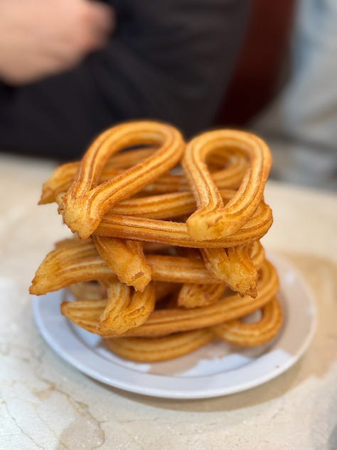 Scenes from Madrid at Christmas, including lights, markets, churros, decorations, and city streets at night.