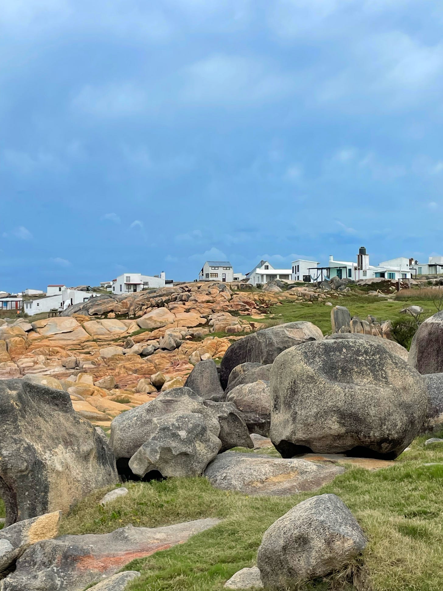 several houses on a hill of rocks in cabo polonio