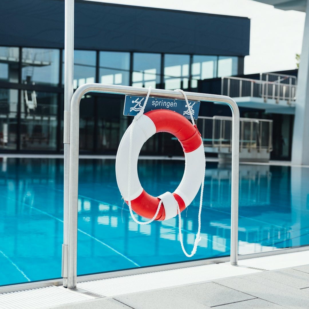 a life preserver on the side of a swimming pool