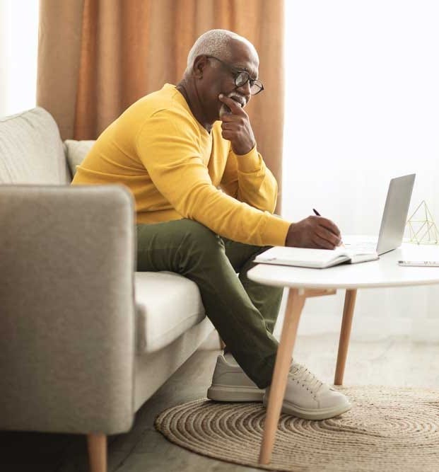 man writing and thinking