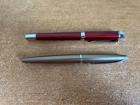Two fountain pens laid out to compare the size of the Ellington Classic fountain pen with an older Cross Fountain pen
