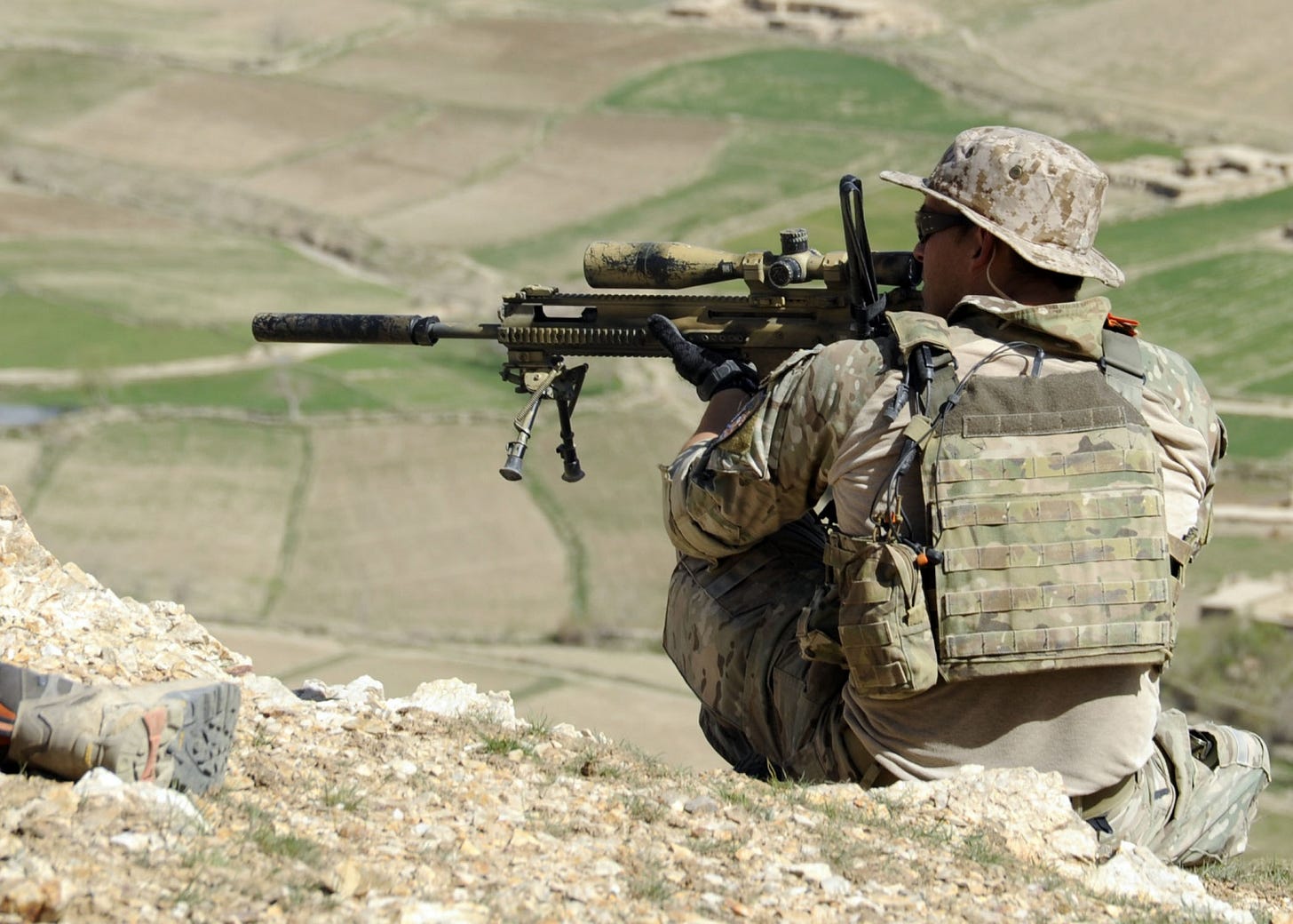 A_coalition_Special_Operations_Forces_member_fires_his_sniper_rifle_from_a_hilltop_during_a_firefight_near_Nawa_Garay_village_(120403-N-MY805-202) A_coalition_Special_Operations_Forces_member_fires_his_sniper_rifle_from_a_hilltop_during_a_firefight_near_Nawa_Garay_village_(120403-N-MY805-202)