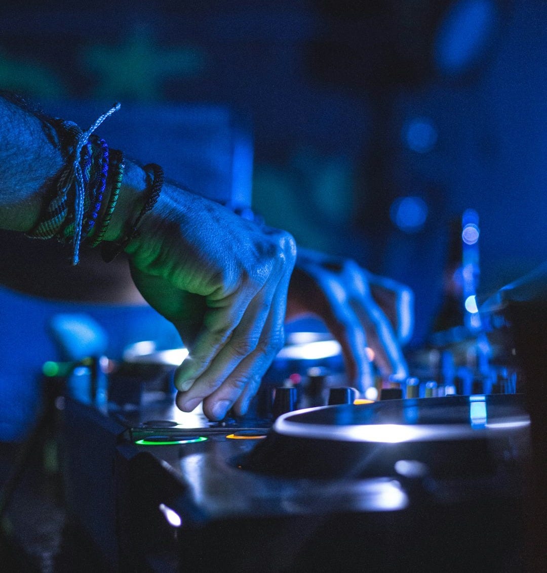 man controlling DJ controller