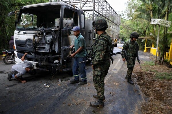 Soldiers stand next to a truck carrying chickens that was set on fire by dissident factions of the former FARC rebels in Jamundi, Colombia, Monday, April 27, 2026. (AP Photo/Santiago Saldarriaga) Soldiers stand next to a truck carrying chickens that was set on fire by dissident factions of the former FARC rebels in Jamundi, Colombia, Monday, April 27, 2026. (AP Photo/Santiago Saldarriaga)
