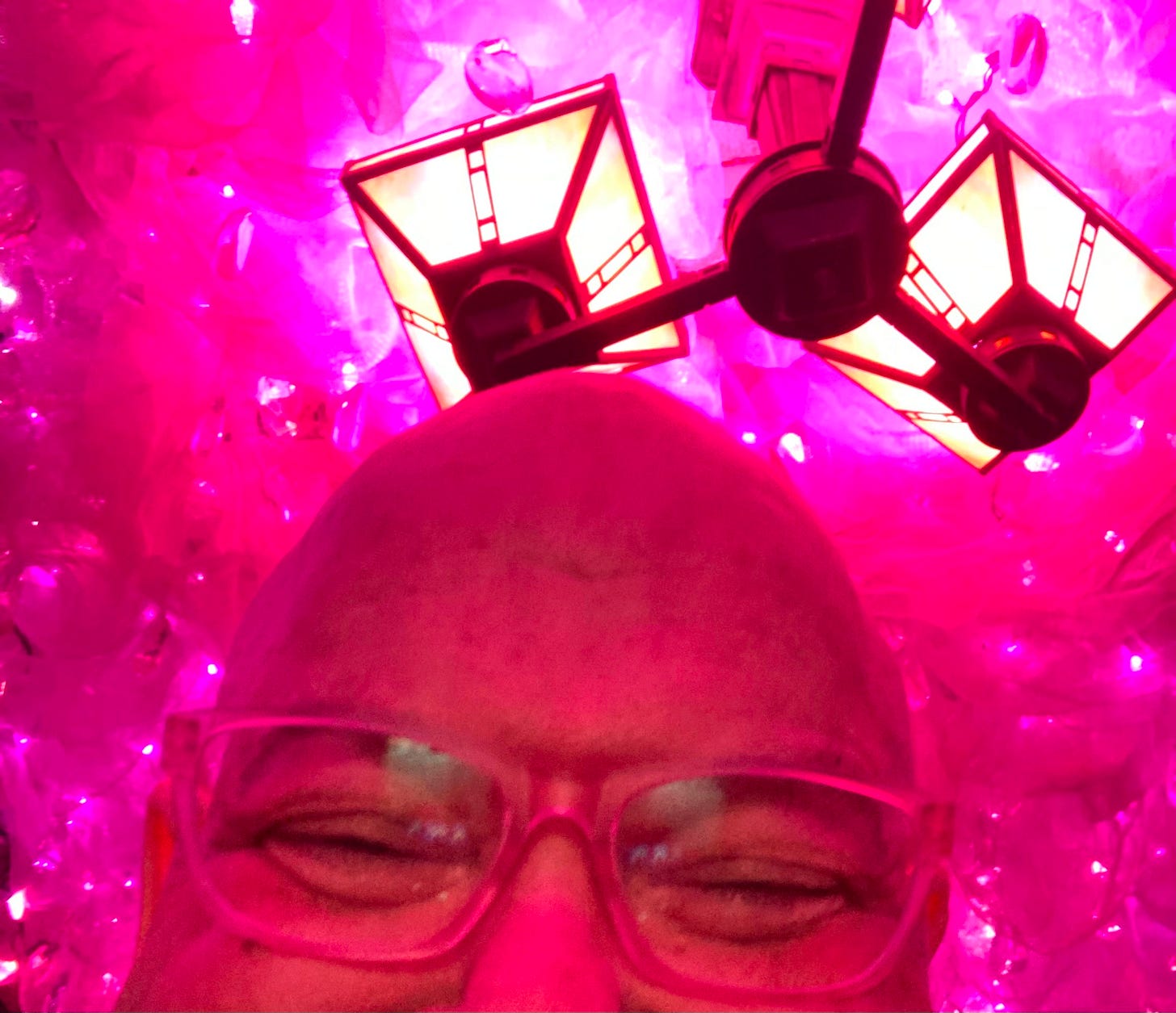 Kirby surrounded by pink lights and feathers at Woody's
