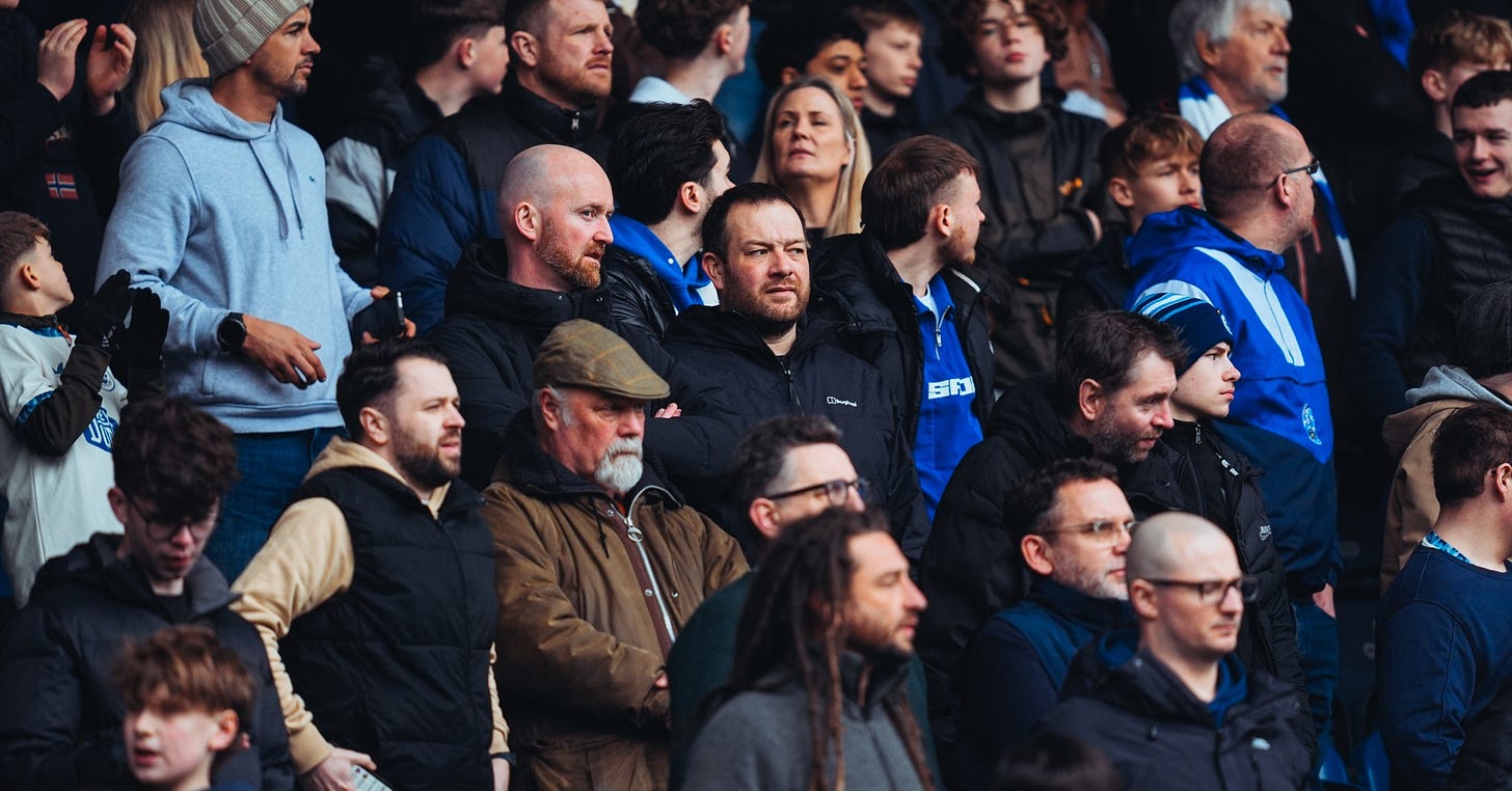 Huddersfield Town fans survey the pitch during their side’s home game against Rotherham United.