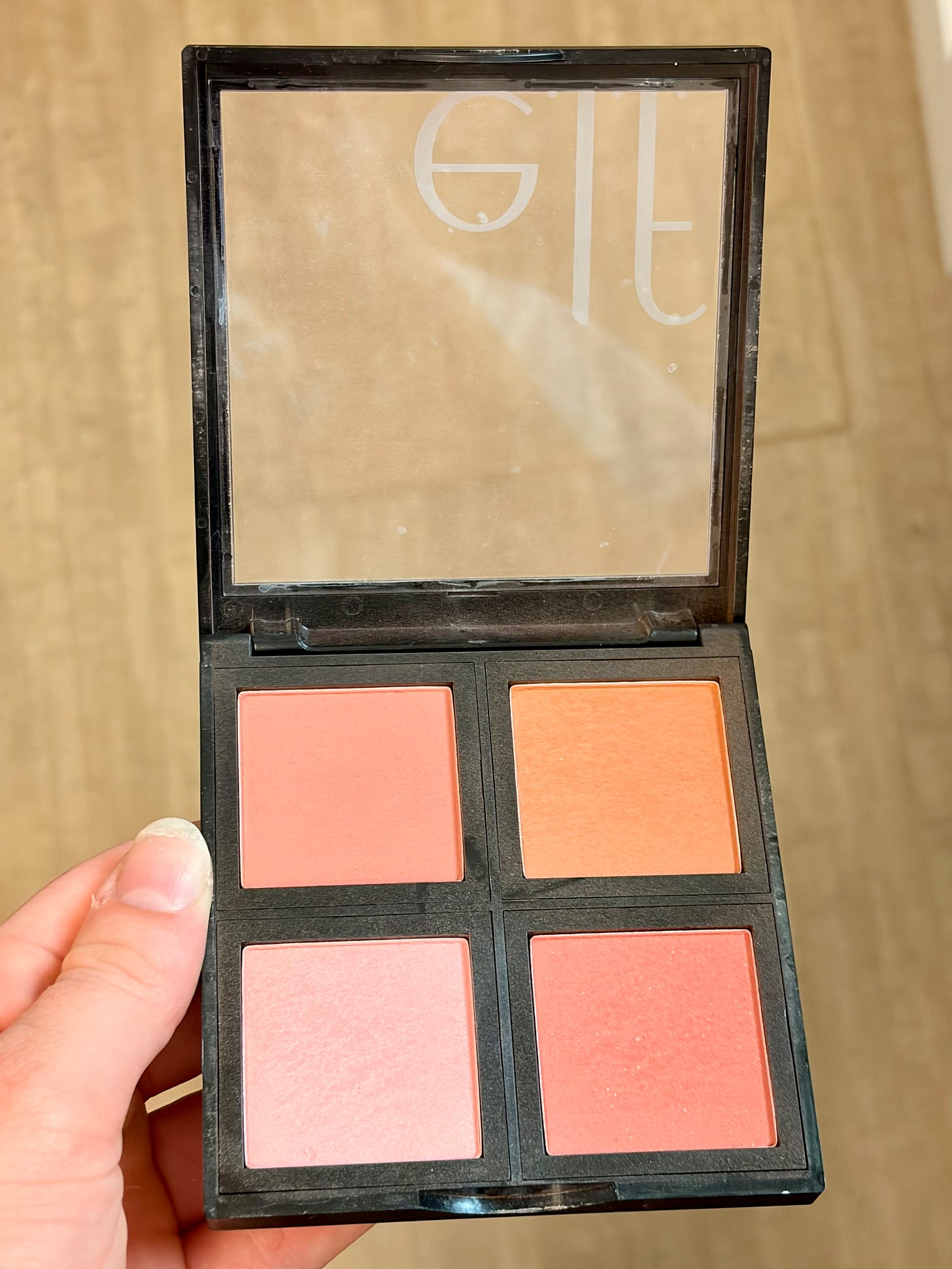n open E.l.f. Cosmetics powder blush palette showing four different complementary shades of pink and rose matte powder blush.