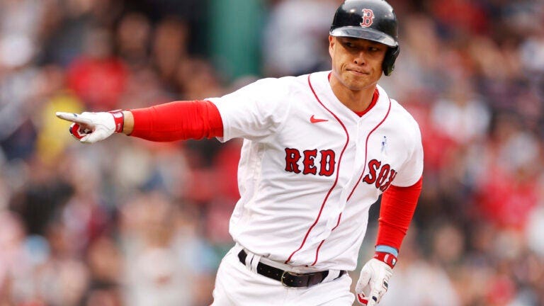 Rob Refsnyder points after an RBI single for the Red Sox