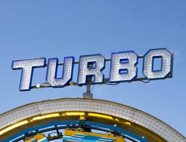 person riding on yellow and blue Turbo roller coaster person riding on yellow and blue Turbo roller coaster