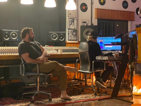 Musical equipment and people inside a recording studio