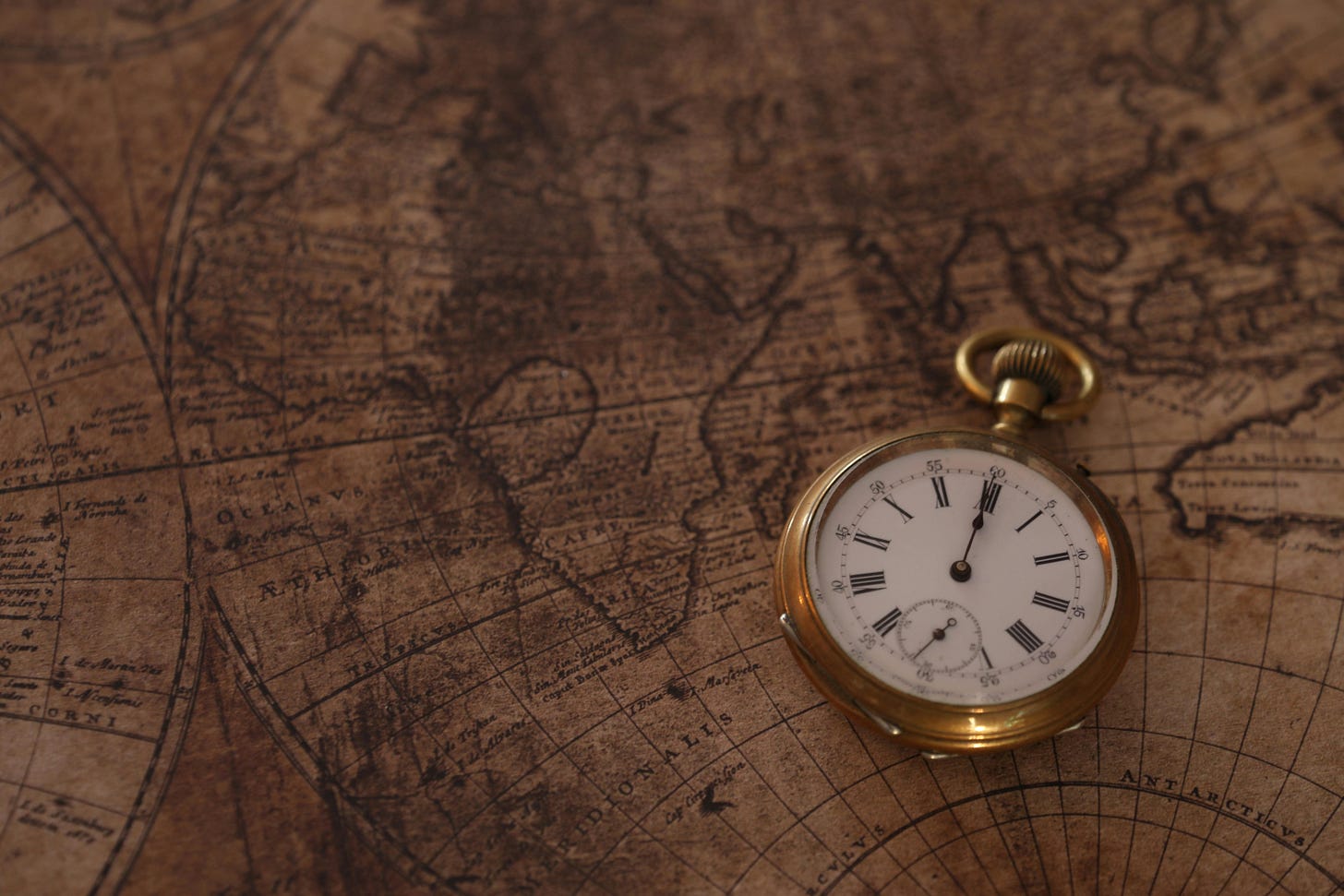 A gold pocket watch resting on an antique world map, the navigation problem GPS solved by hiding the clock in orbit. A gold pocket watch resting on an antique world map, the navigation problem GPS solved by hiding the clock in orbit.