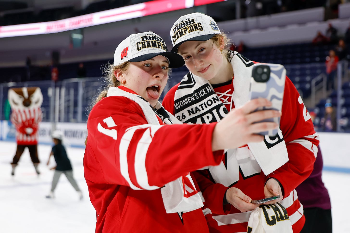 Cassie Hall and Laney Potter hold up a phone to take a photo