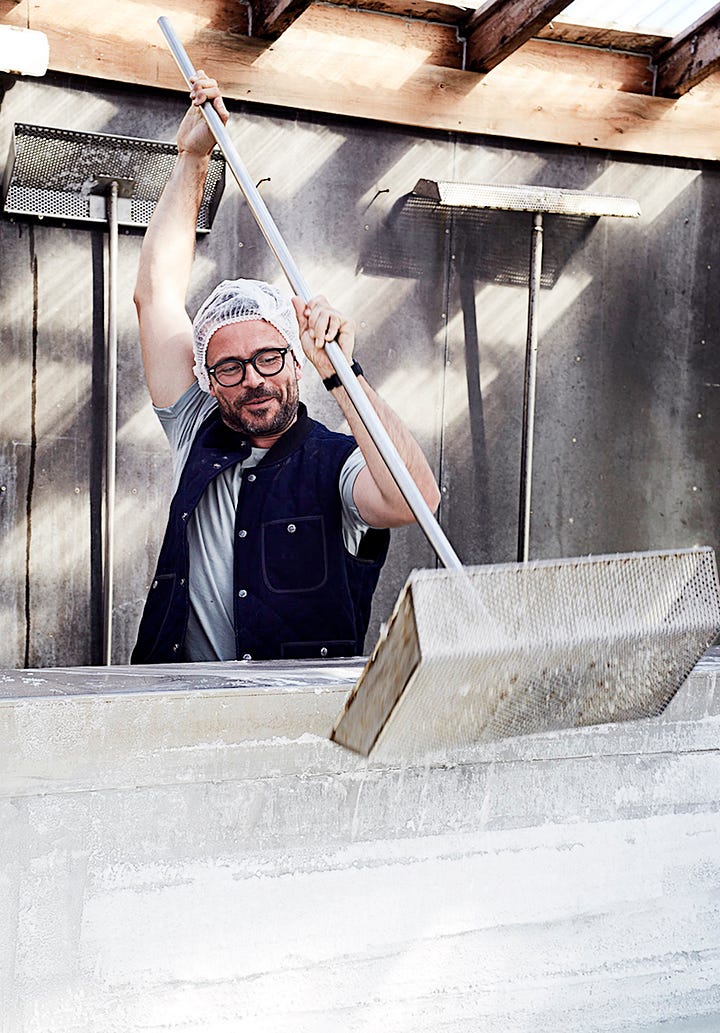 man turning salt and close up of salt flakes with seaweed