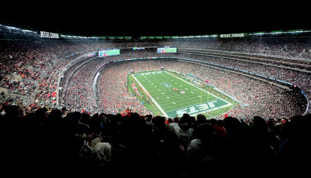 a stadium filled with lots of people watching a football game
