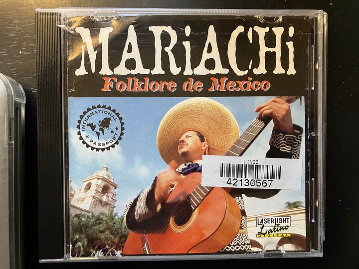 Four photos of a compact disc music player and three Spanish music compact discs (CDs)