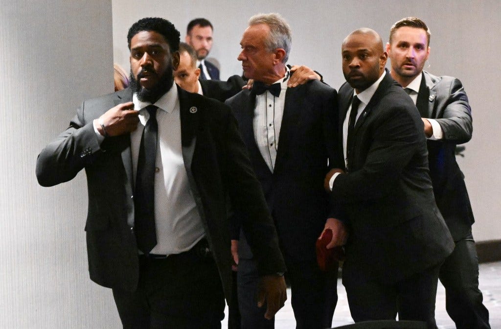 Robert F. Kennedy Jr. being rushed out by Secret Service agents during the White House Correspondents' dinner.