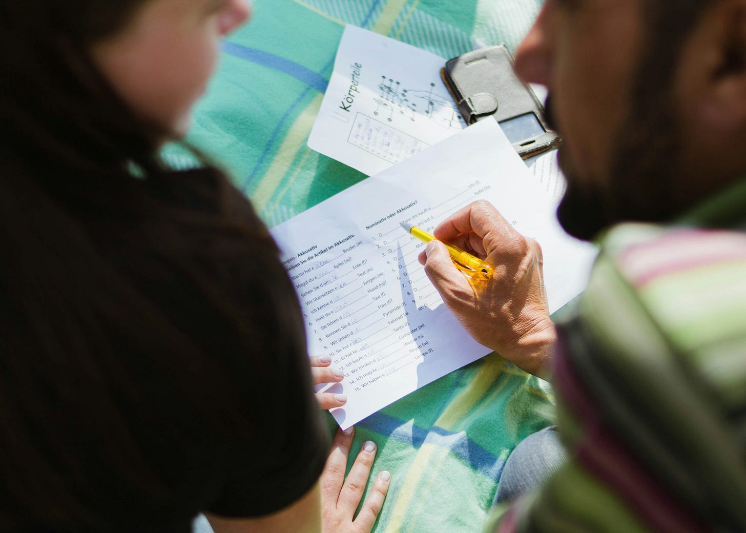A teacher helping a student understand her answers A teacher helping a student understand her answers