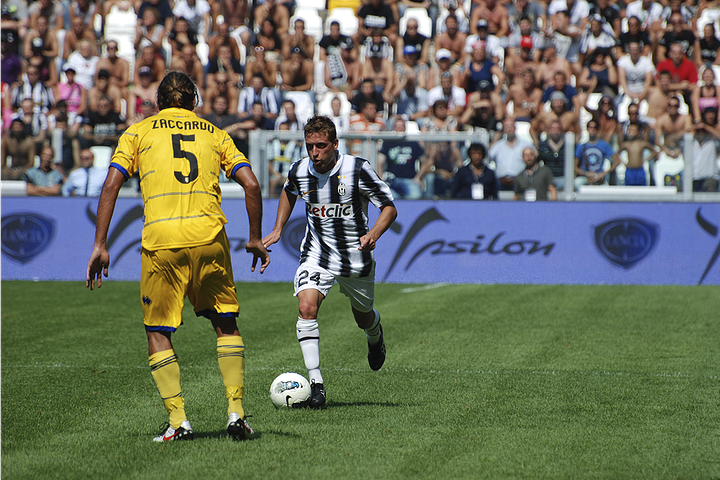 Juventus vs Parma, September 11, 2011: team huddle, player introductions, Antonio Conte coaching from the sideline, Pirlo and Del Piero in action, and Juventus players celebrating a goal during the opening match at Juventus Stadium.