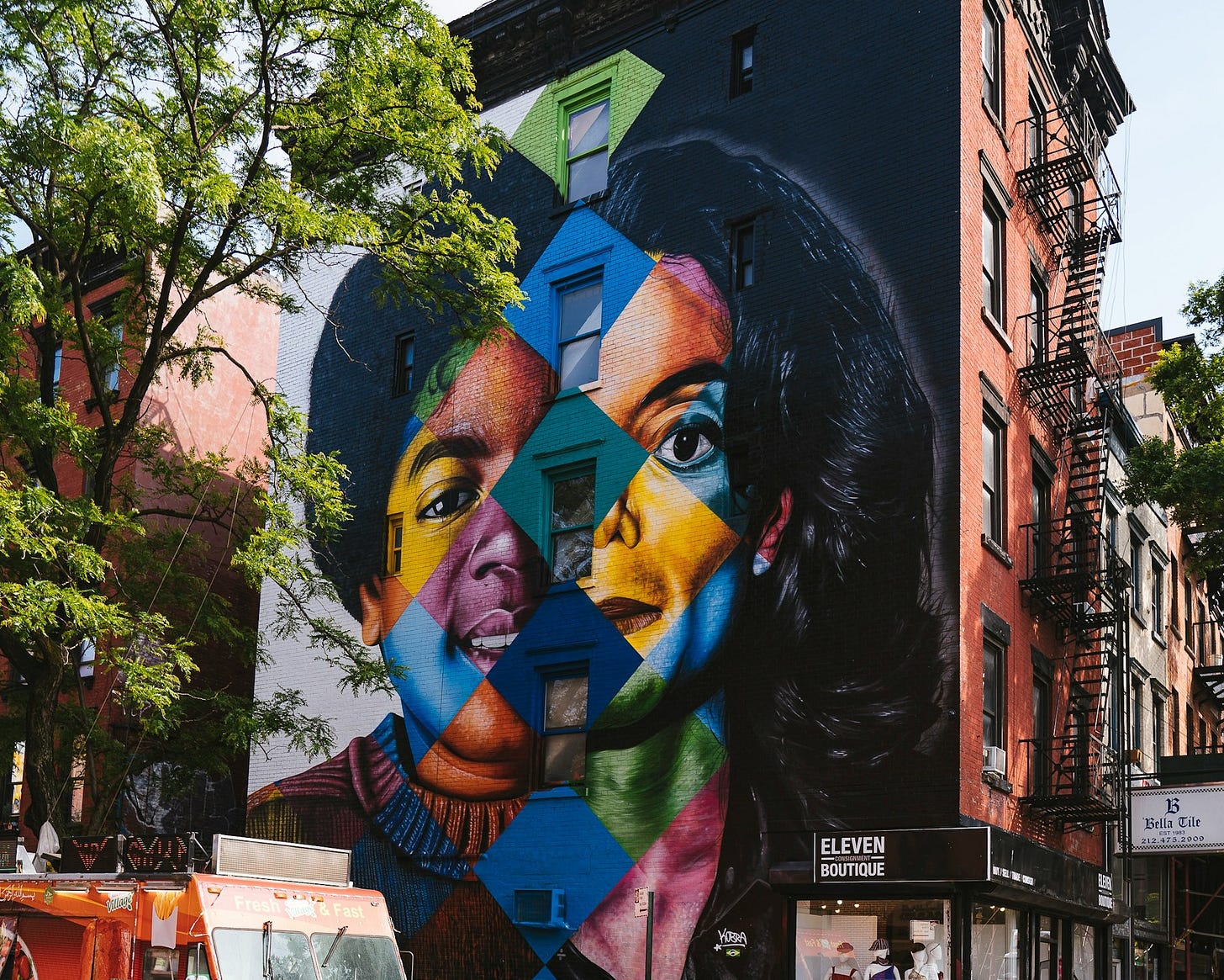 Painting on the side of a building showing Michael Jackson as a teenager and as an adult.
