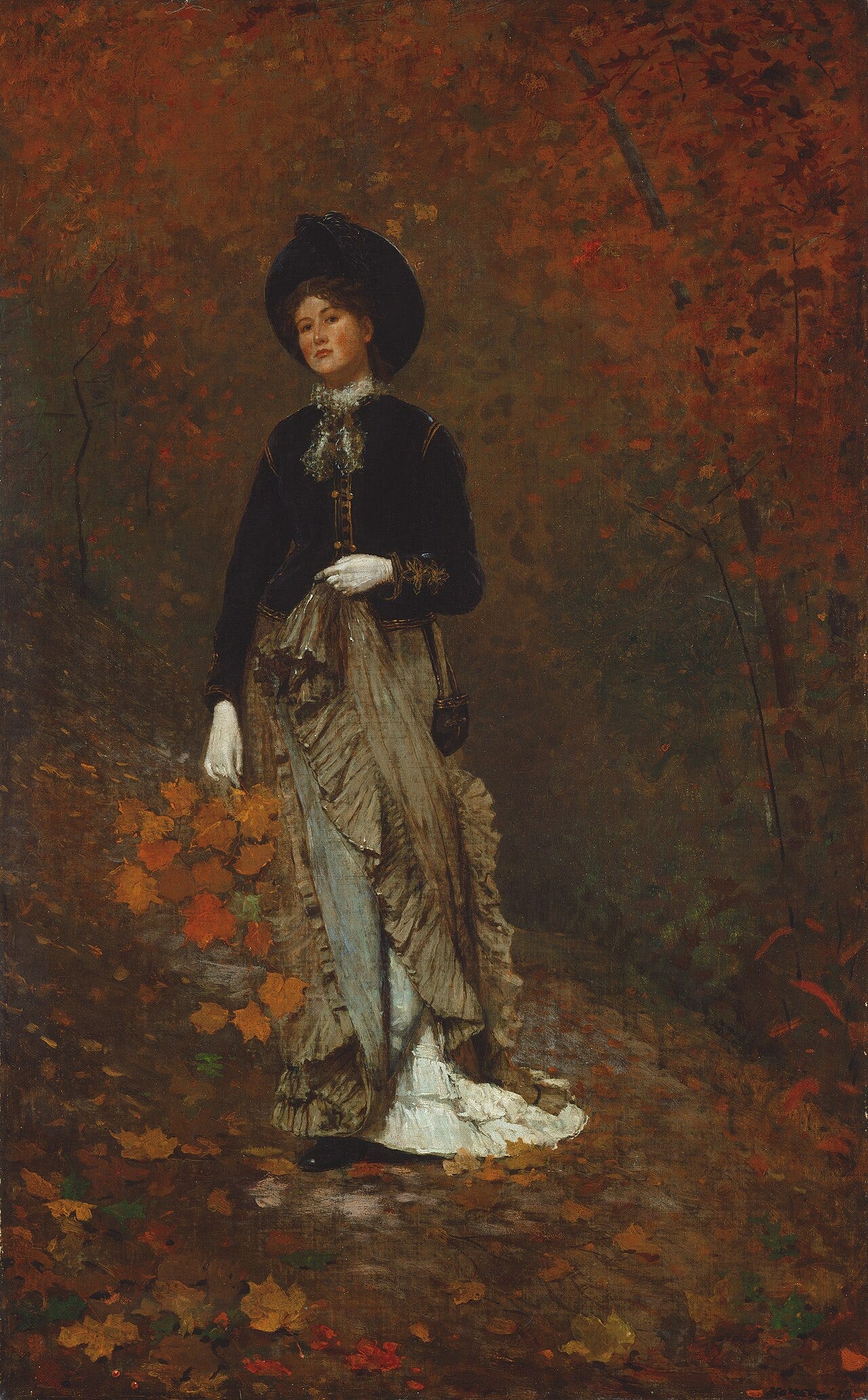 A woman in a wood holding a bunch of bright autumn leaves A woman in a wood holding a bunch of bright autumn leaves