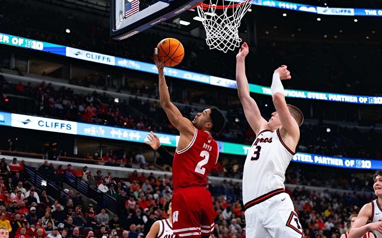 Wisconsin guard Nick Boyd finishes at the basket over an Illinois defender during a Big Ten Tournament game. Photo credit: UW Athletics.
