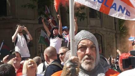 A person holding a flag and holding a flag

AI-generated content may be incorrect.