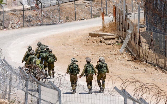 Israeli troops patrol the border fence with Syria near the Druze village of Majdal Shams in the Golan Heights on July 23, 2025 (Jalaa MAREY / AFP)