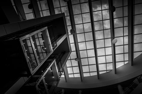 scenes from around campus including a classroom with calculations on whiteboard, ceiling images of cables to power makers space, University of Memphis logo on a chair and window, buildings