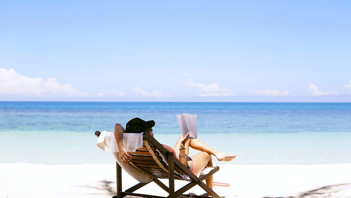 woman sitting in chair on beach