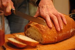 Cutting warm bread, at Q's party, Broadview Ne...