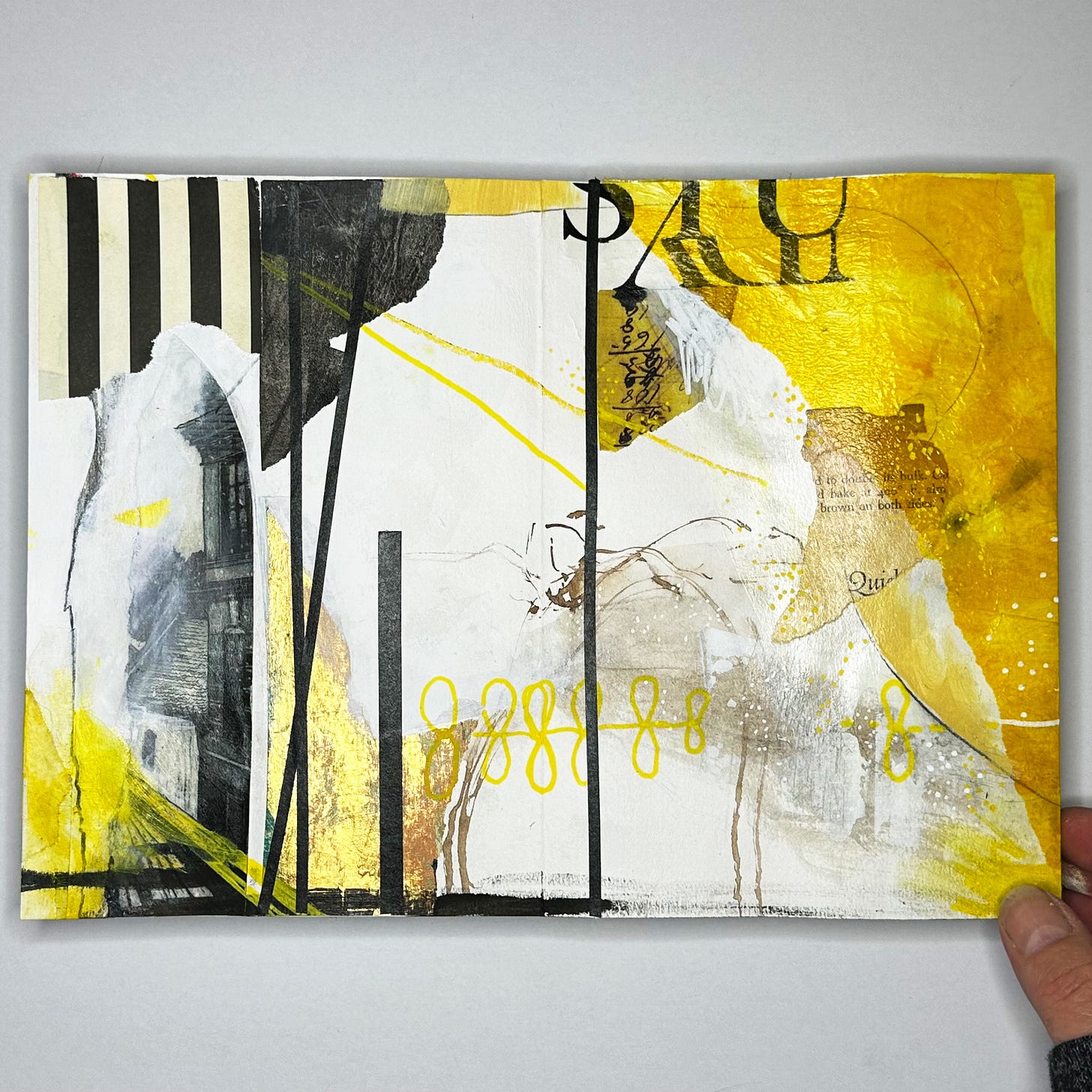 Sketchbook spread showing abstract mixed-media painting in yellow and shades of black and white
