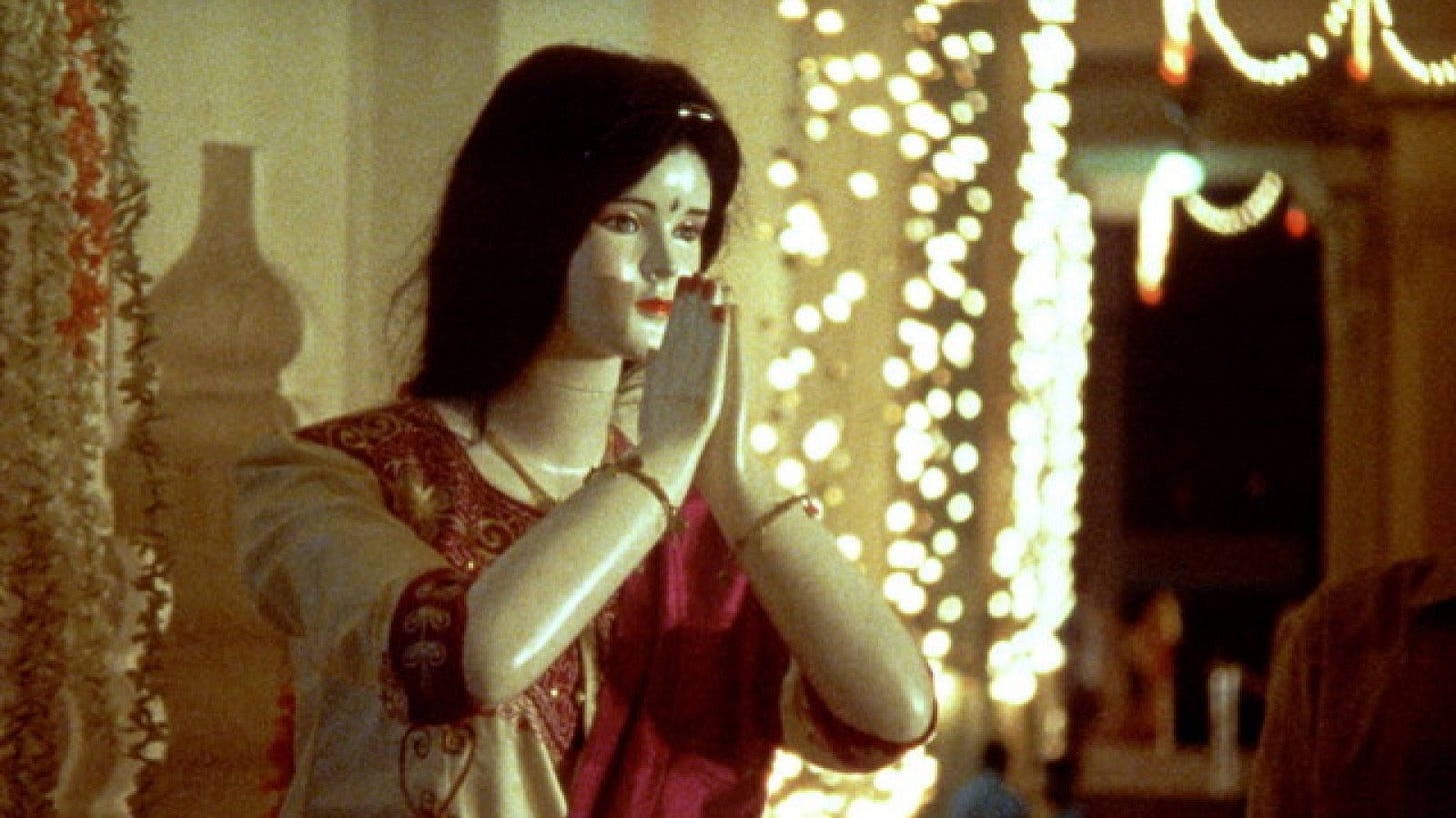 Gambling, Gods and LSD | Still features a praying statue.