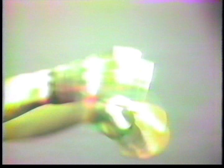 Rapid hand-gestures blur and bleed across the screen as gibberish is rhythmically spoken off-screen