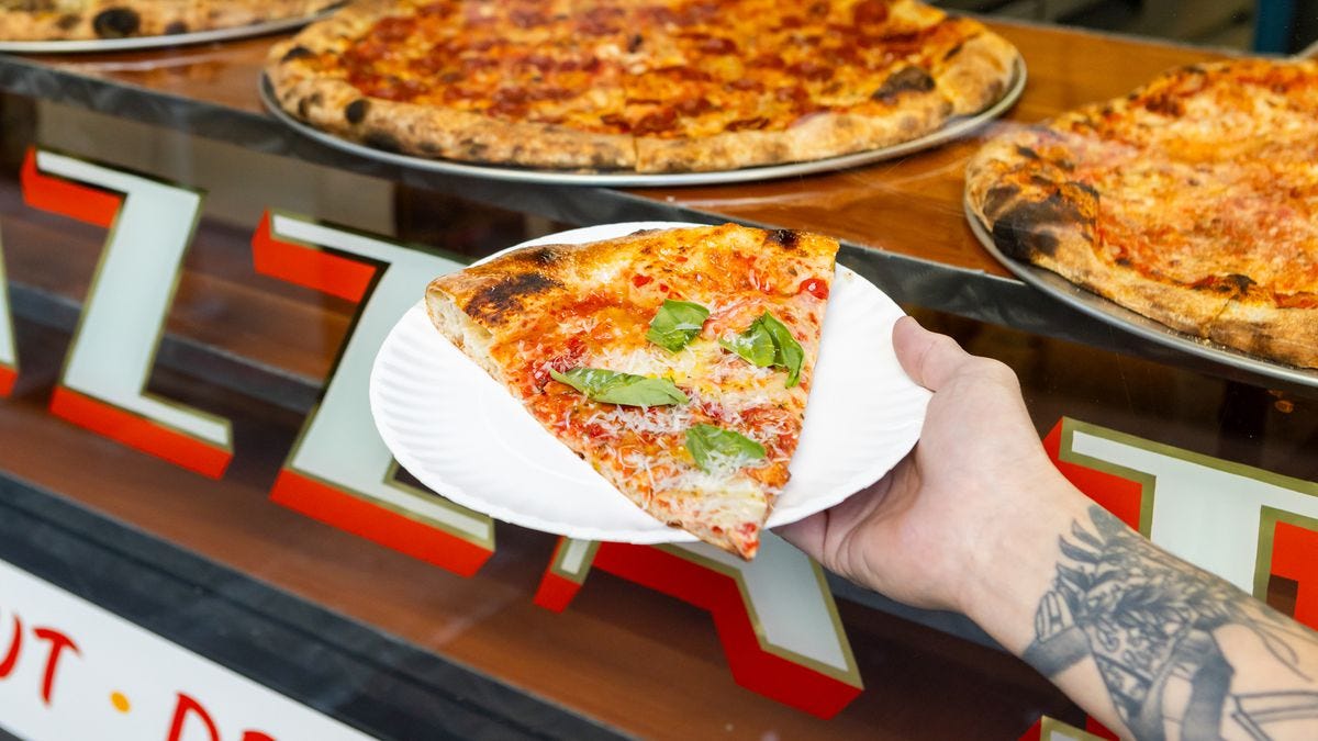 A slice of pizza on a plate from Outta Sight Pizza in San Francisco.