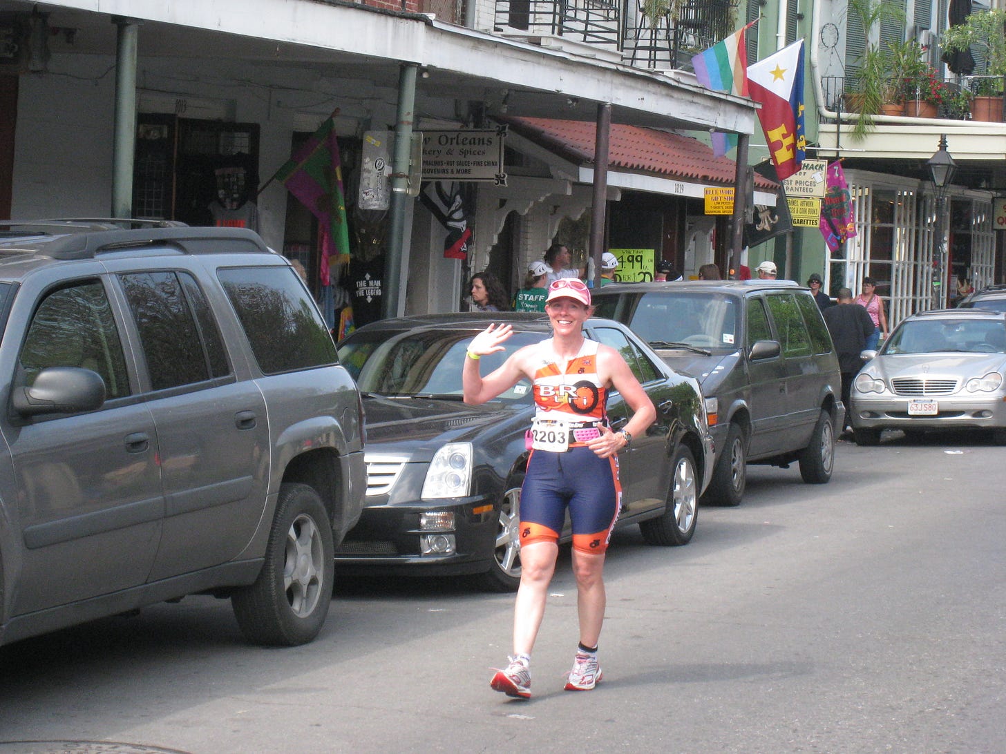 Elizabeth running through the French Quarter during the race, waving and smiling