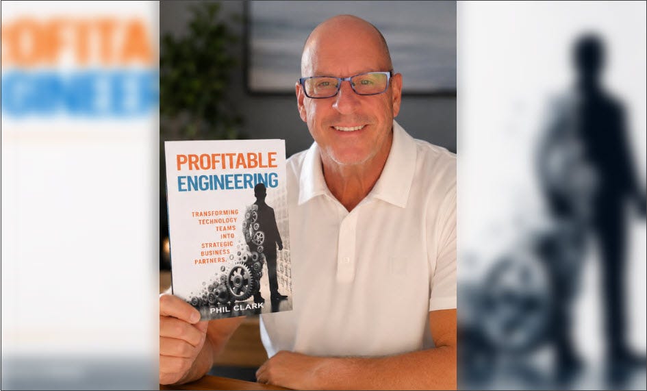 Phil Clark holding a copy of Profitable Engineering