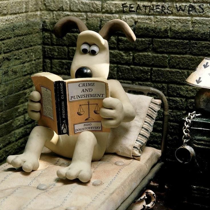 This may contain: a statue of a dog reading a book