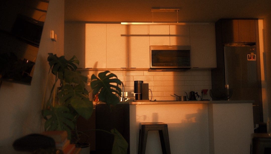 Kitchen illuminated by warm sunset light.