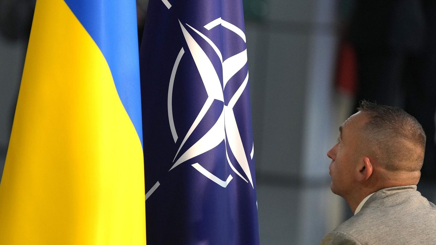 A member of protocol sets up the NATO and Ukrainian flags in Brussels, Wednesday, Oct. 11, 2023. - Sputnik International, 1920, 25.01.2025