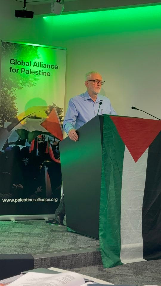May be an image of 2 people, dais and text that says "f for Palestine Global Alliance www.palestine-alliance.org www.palestine- alliance. org" May be an image of 2 people, dais and text that says "f for Palestine Global Alliance www.palestine-alliance.org www.palestine- alliance. org"