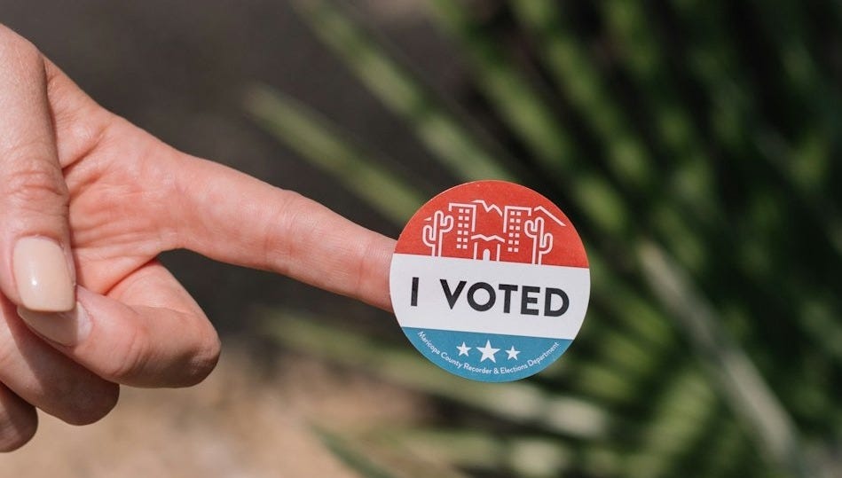 person holding red and white round pin