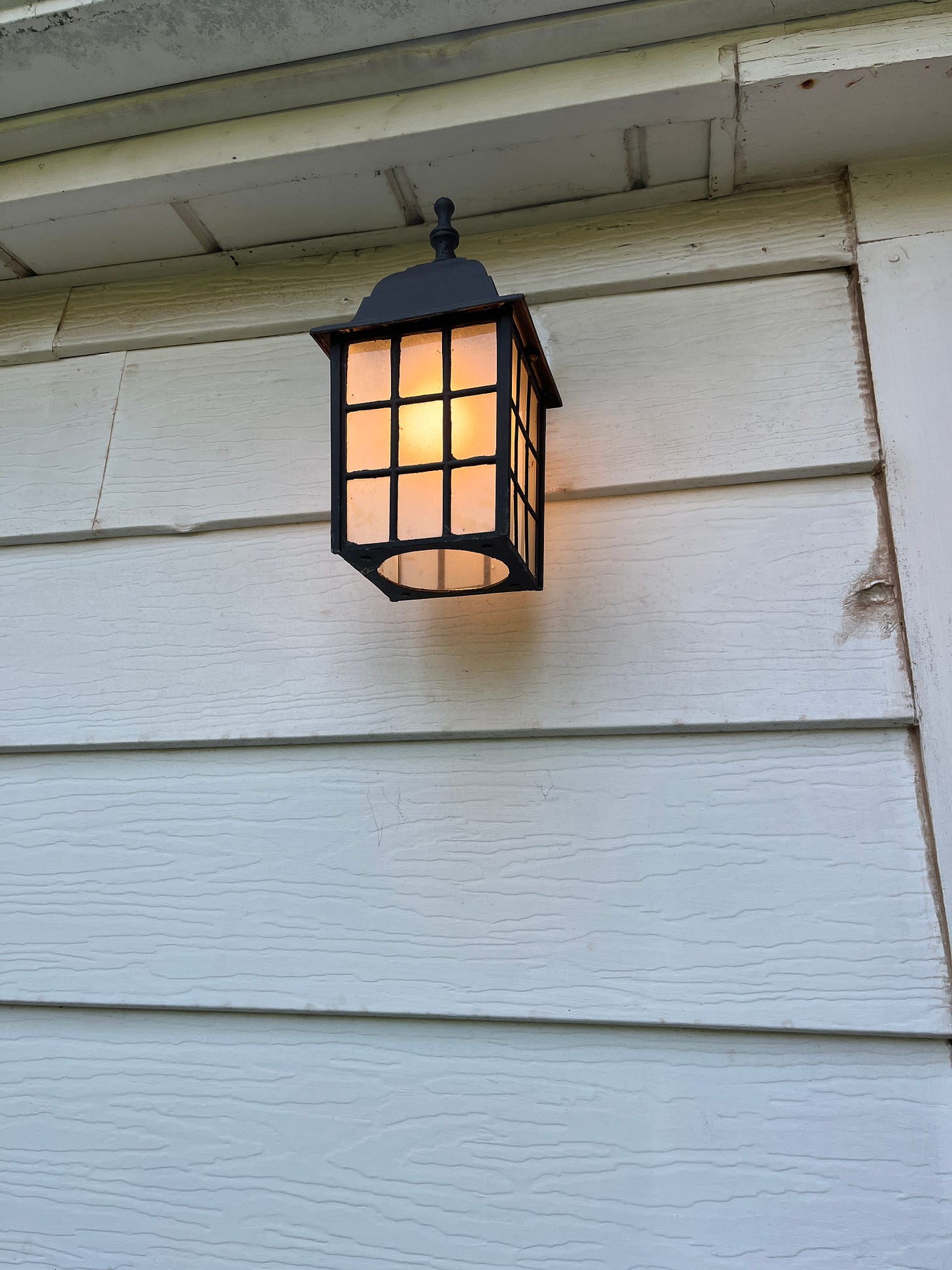 A simple porch light fixture at the back of our house