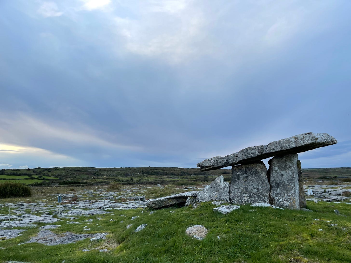 A photograph of Poulnabrone Dolmen in County Clare, Ireland on a cool-blue cloudy day A photograph of Poulnabrone Dolmen in County Clare, Ireland on a cool-blue cloudy day