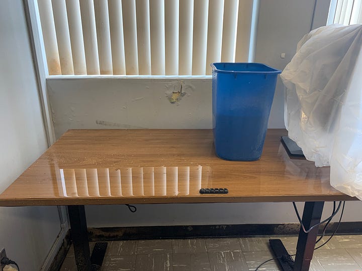 images depict ceilings with fallen tiles exposing brown glue, flooded desks and classrooms, buckets to carry water for leaks, furniture cover with plastic bags