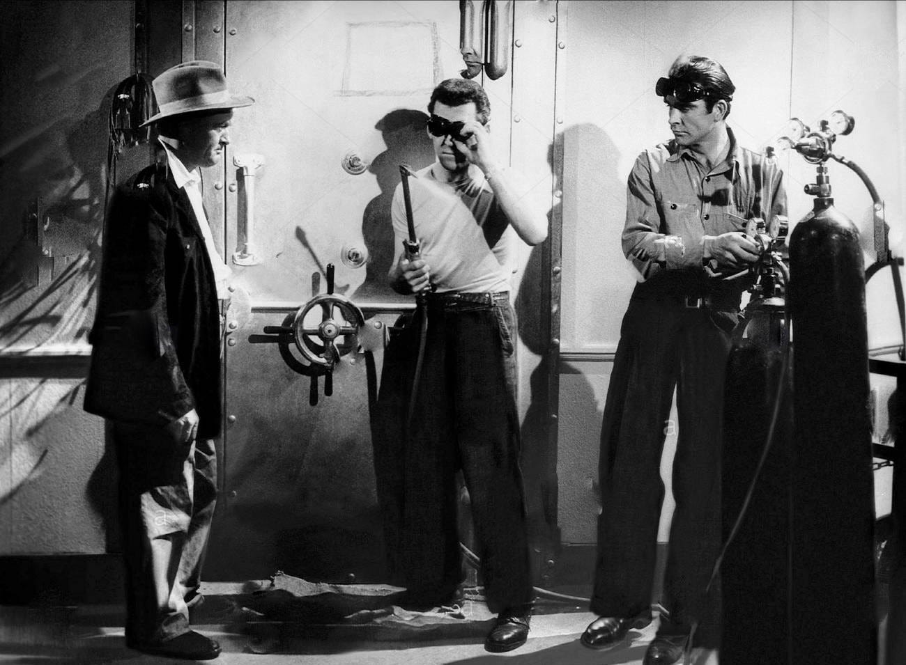 A sheriff and two welders, one played by Sean Connery, stand in front of a safe door A sheriff and two welders, one played by Sean Connery, stand in front of a safe door