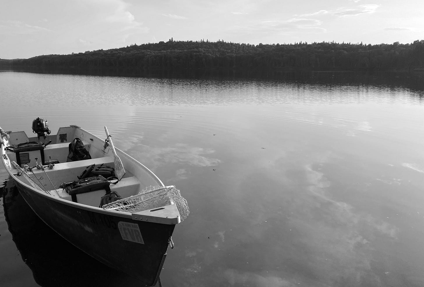 Fiberglass boat on a pristine lake in the Quebec wilderness. Fiberglass boat on a pristine lake in the Quebec wilderness.