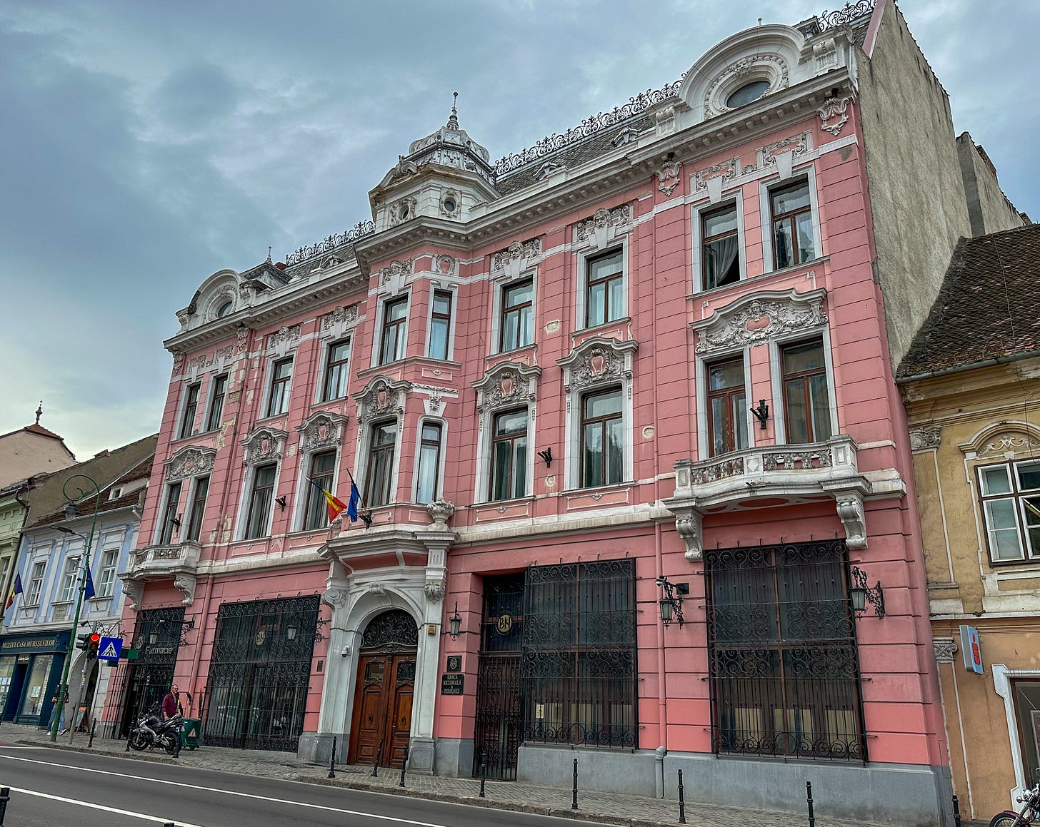 The beautiful, centuries-old pink building houses the National Bank in Brasov