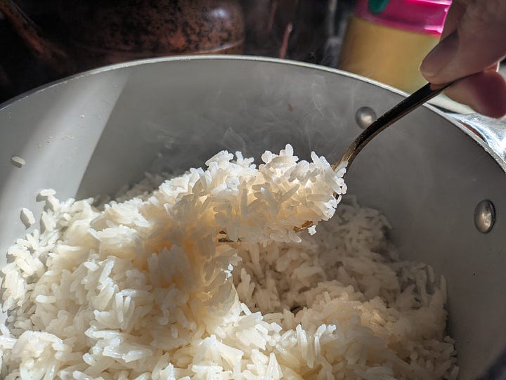 Freshly opened coconut, photo by Jonas Ducker via Unsplash. Coconut rice from the below recipe being fluffed.