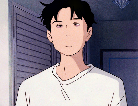 This may contain: a young man in a white shirt staring at the camera
