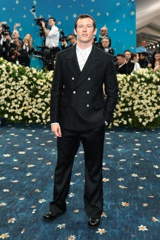 Image may contain Callum Turner Arnon Grunberg Clothing Formal Wear Suit Person Standing Adult Accessories and Tie